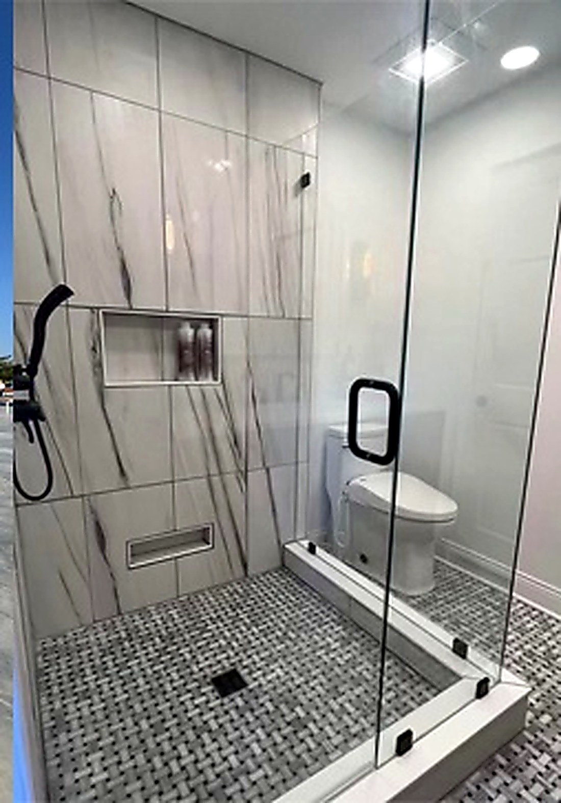Tiled walk-in shower with frameless glass